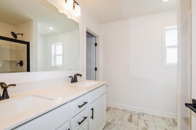 bathroom with plenty of natural light, marble finish floor, visible vents, and a sink