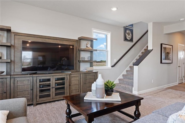 living room with baseboards, stairway, and recessed lighting