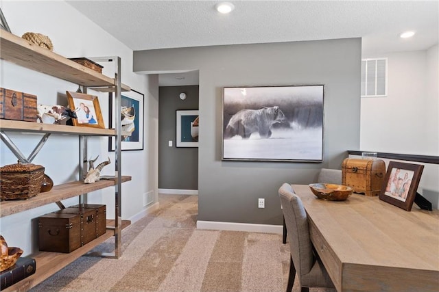 carpeted home office featuring visible vents, baseboards, a textured ceiling, and recessed lighting