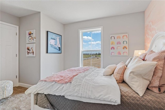 carpeted bedroom with baseboards