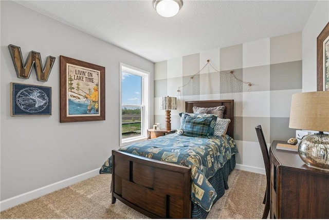 bedroom with a textured ceiling, carpet floors, and baseboards