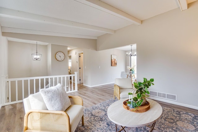 sitting room featuring baseboards, visible vents, a chandelier, and beamed ceiling