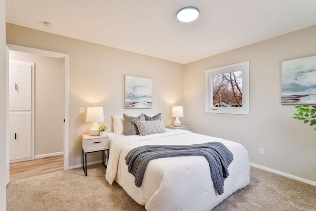 bedroom with carpet floors and baseboards