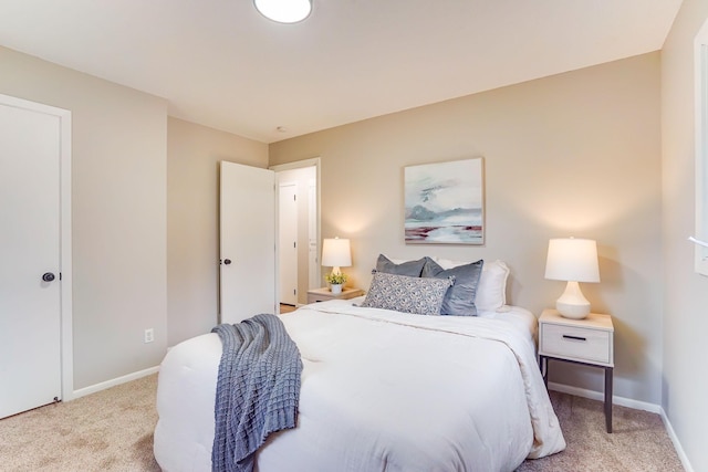 carpeted bedroom featuring baseboards