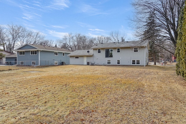 rear view of property featuring a yard