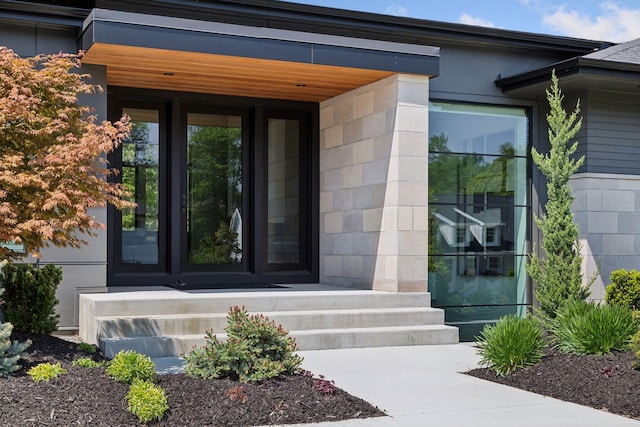 doorway to property featuring concrete block siding