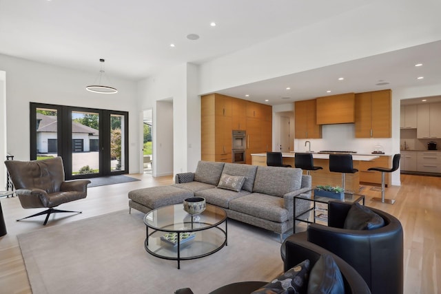 living area with light wood-type flooring and recessed lighting