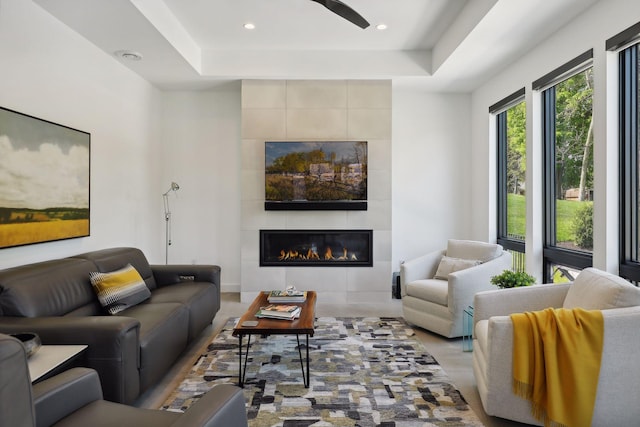 living room featuring recessed lighting, a fireplace, and ceiling fan