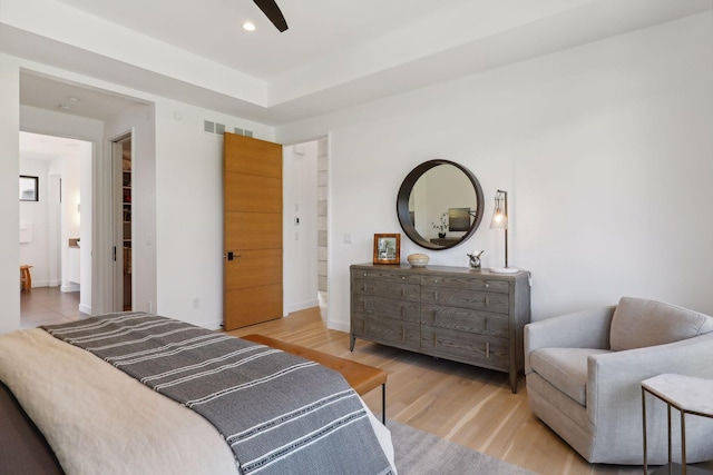 bedroom featuring baseboards, wood finished floors, and recessed lighting