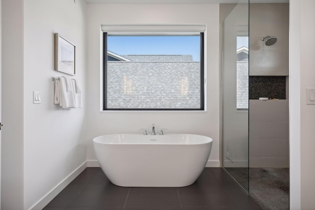 full bath featuring a soaking tub, tile patterned flooring, baseboards, and walk in shower