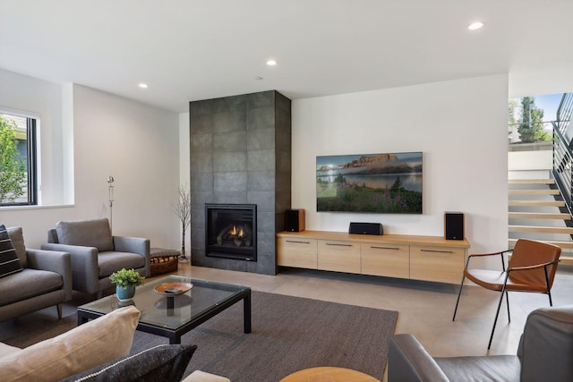 living room with stairway, recessed lighting, a fireplace, and a healthy amount of sunlight