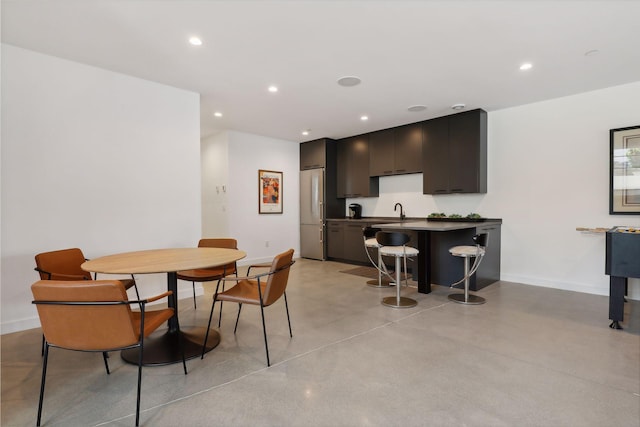 dining room featuring recessed lighting, concrete floors, and baseboards