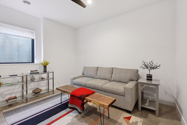 living room featuring ceiling fan and baseboards