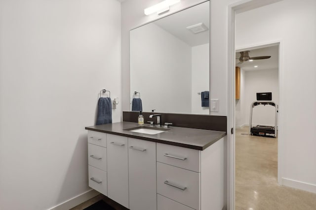 bathroom with ceiling fan, concrete floors, baseboards, and vanity