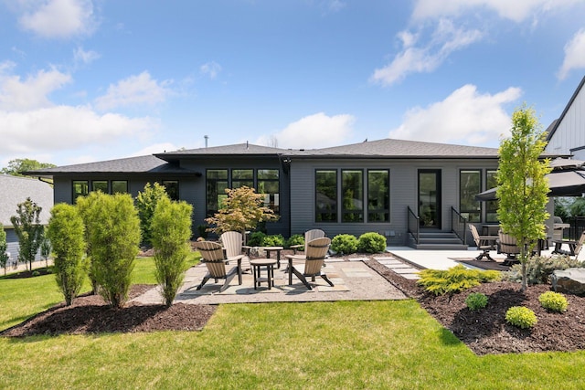 back of house with a yard and a patio