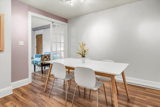 79 Western Ave N Unit 305, Saint Paul, MN 55102 - dining area featuring wood finished floors, baseboards, and a textured ceiling
