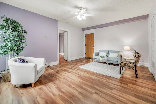 79 Western Ave N Unit 305, Saint Paul, MN 55102 - living area featuring a ceiling fan, baseboards, wood finished floors, and baseboard heating