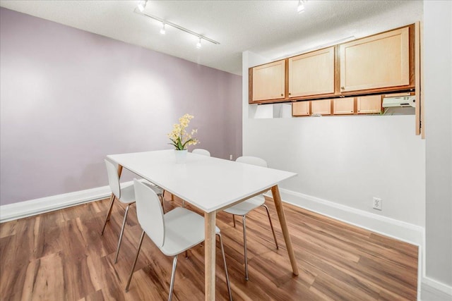 79 Western Ave N Unit 305, Saint Paul, MN 55102 - dining room featuring rail lighting, wood finished floors, and baseboards