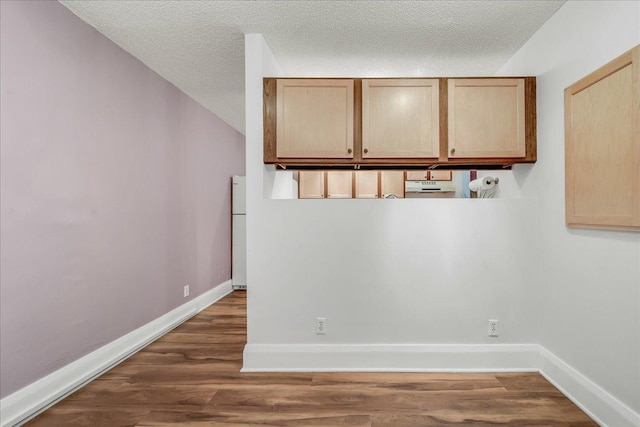 79 Western Ave N Unit 305, Saint Paul, MN 55102 - washroom featuring a textured ceiling, wood finished floors, and baseboards