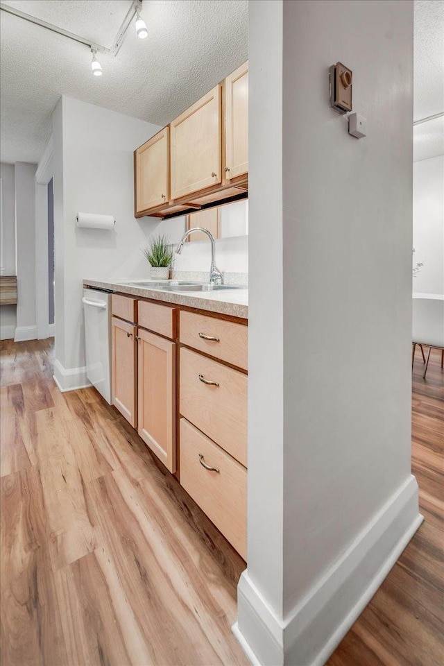 79 Western Ave N Unit 305, Saint Paul, MN 55102 - kitchen with light brown cabinets, white dishwasher, light wood-type flooring, light countertops, and a textured ceiling
