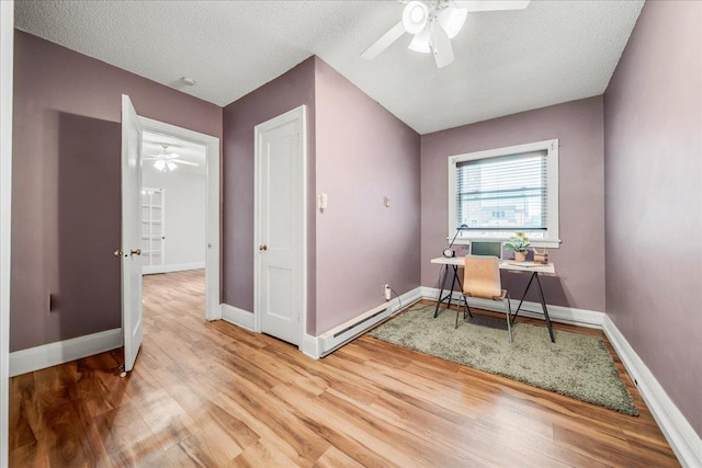79 Western Ave N Unit 305, Saint Paul, MN 55102 - office featuring a ceiling fan, wood finished floors, a baseboard radiator, baseboards, and a textured ceiling