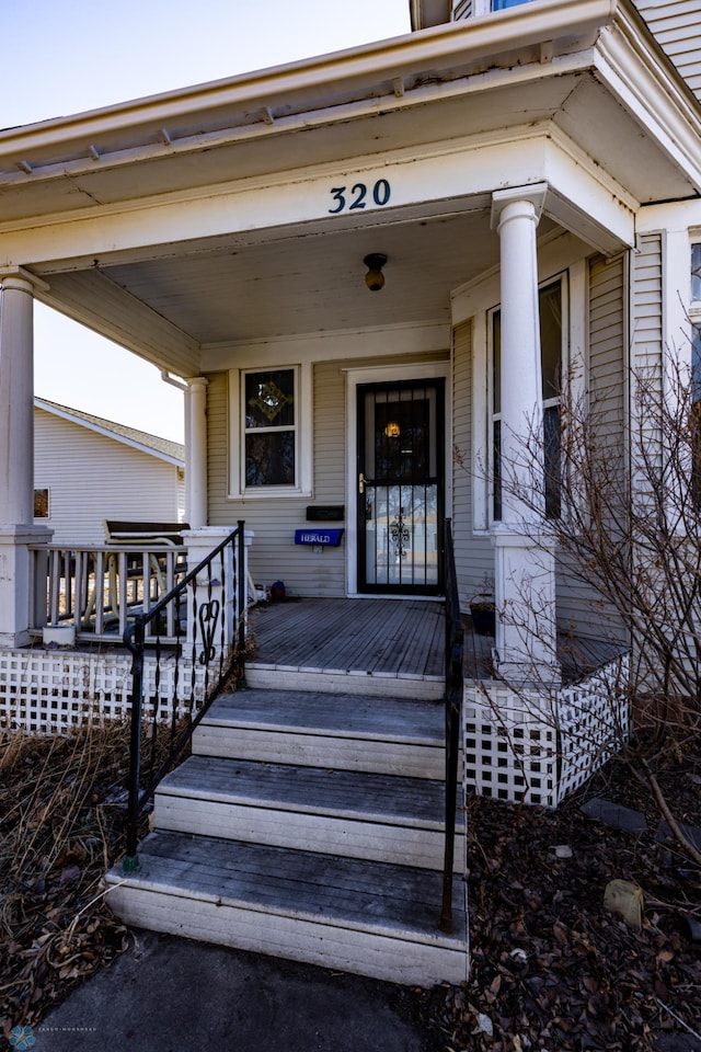 view of exterior entry with a porch