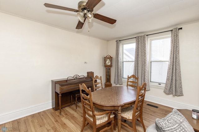 dining space featuring visible vents, baseboards, and light wood-style flooring