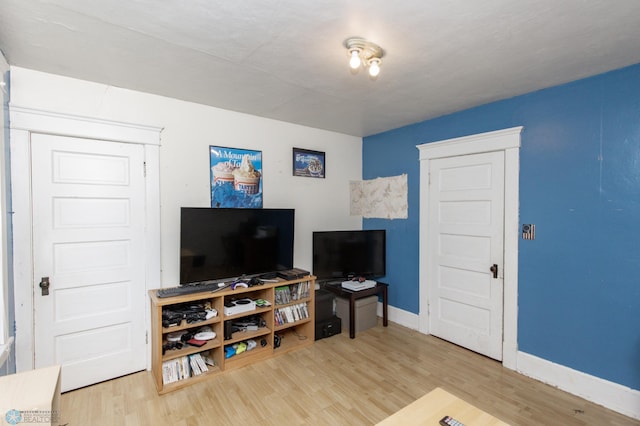 living room featuring baseboards and wood finished floors