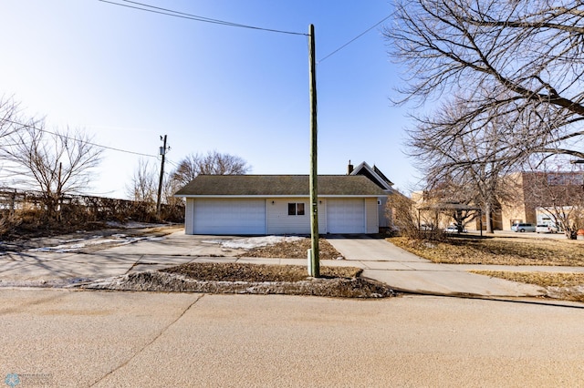 view of front of home with concrete driveway and an attached garage