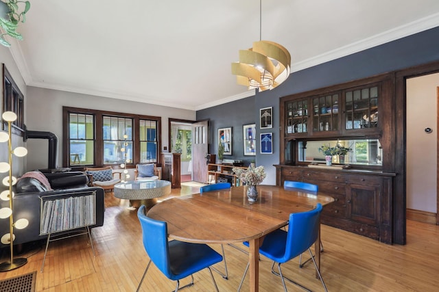 dining room with hardwood / wood-style flooring and ornamental molding