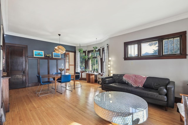 living room featuring crown molding and light wood-style floors