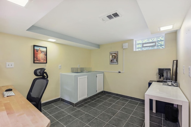 home office featuring baseboards, visible vents, and dark tile patterned flooring