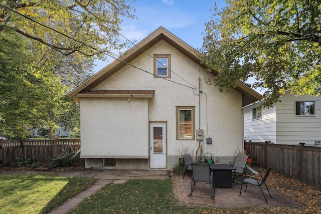 back of property with a patio area, a fenced backyard, and stucco siding