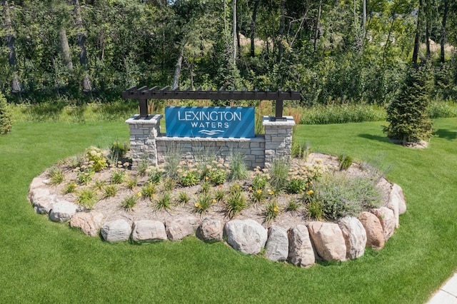 community / neighborhood sign with a yard