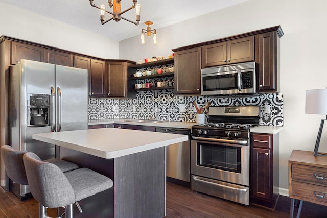 kitchen featuring dark brown cabinets, dark wood-type flooring, decorative backsplash, stainless steel appliances, and open shelves