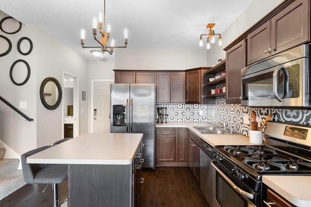 kitchen featuring open shelves, decorative backsplash, an inviting chandelier, stainless steel appliances, and a sink