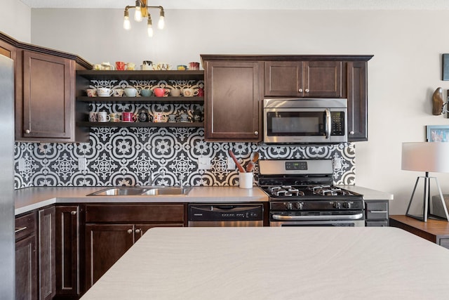 kitchen featuring open shelves, a sink, appliances with stainless steel finishes, light countertops, and dark brown cabinets