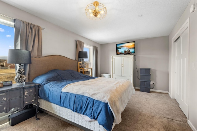 bedroom with carpet flooring and baseboards