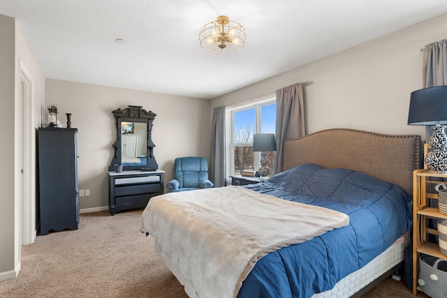 bedroom with baseboards and light carpet