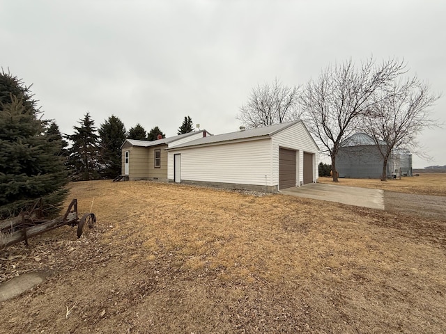 view of side of property featuring a detached garage