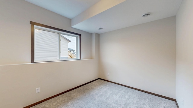 unfurnished room featuring visible vents, baseboards, and carpet flooring