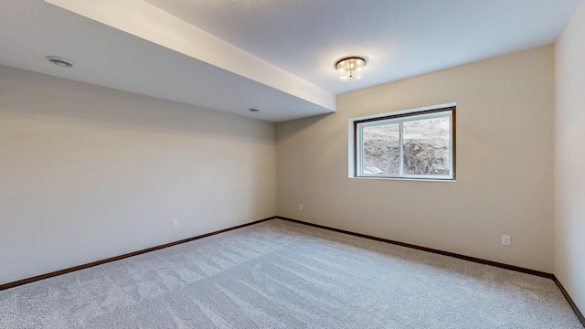 carpeted empty room with baseboards