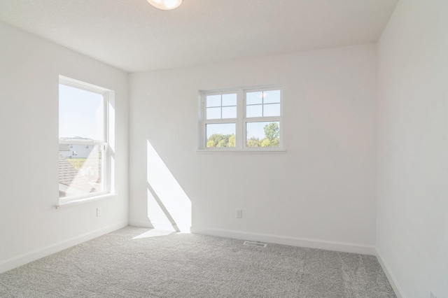 carpeted spare room with baseboards