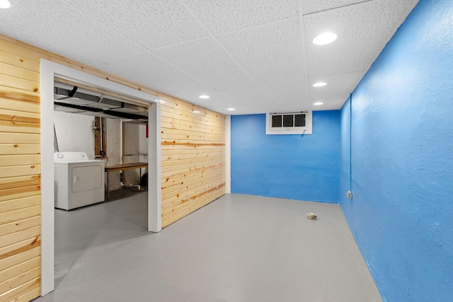 finished below grade area with recessed lighting, washer / clothes dryer, and a textured wall