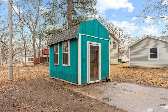 view of outbuilding featuring an outbuilding and fence