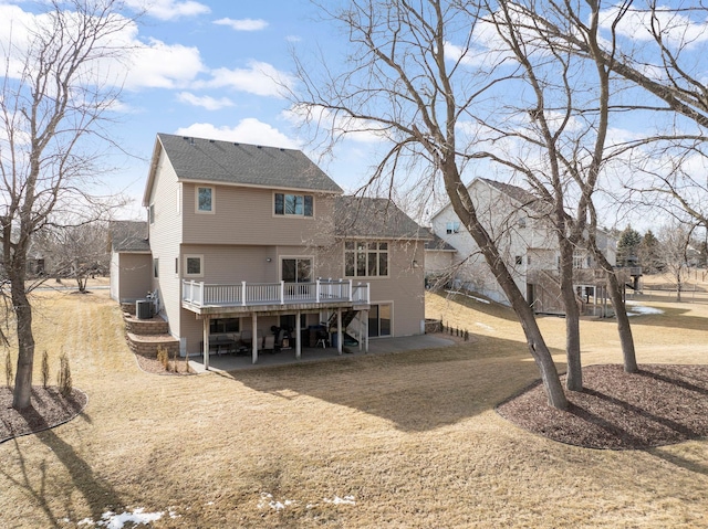 rear view of property with a patio area, a deck, and roof with shingles