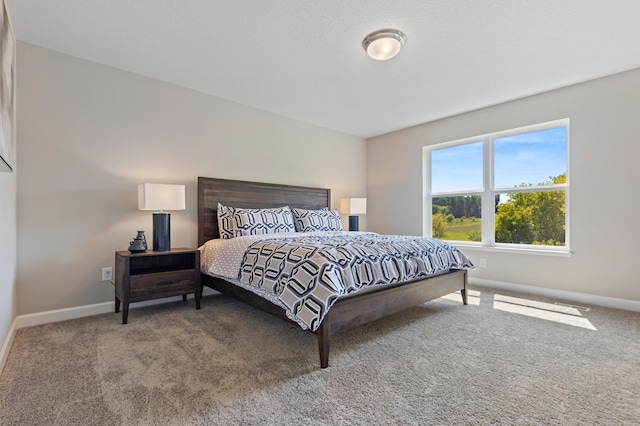 carpeted bedroom featuring baseboards