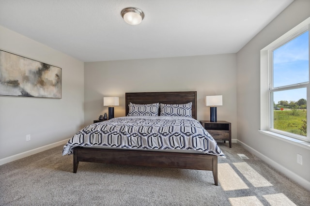 carpeted bedroom featuring visible vents and baseboards