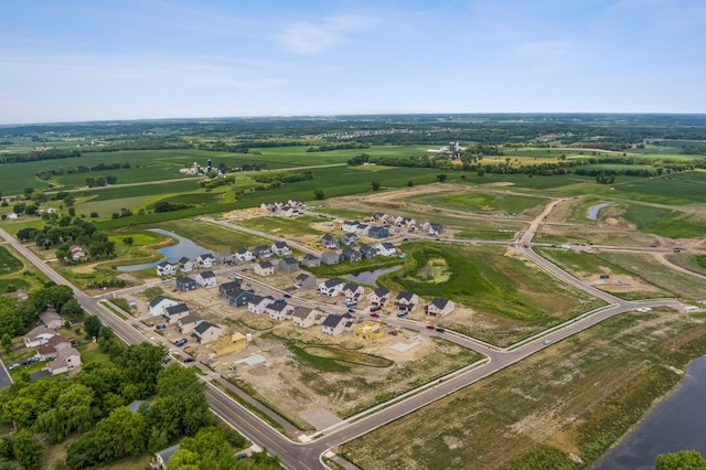 birds eye view of property featuring a water view and a rural view