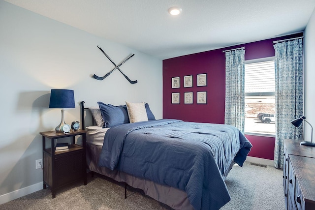 carpeted bedroom featuring visible vents and baseboards